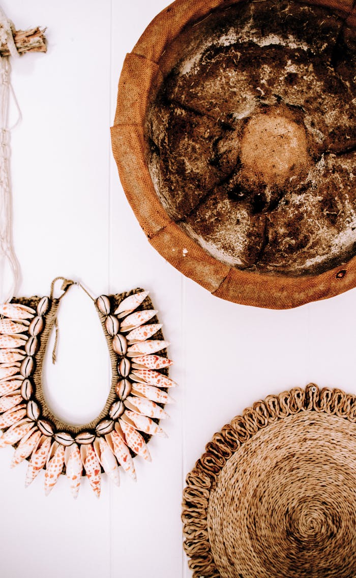 Artistic bohemian wall decor featuring natural seashell ornaments and woven textures.